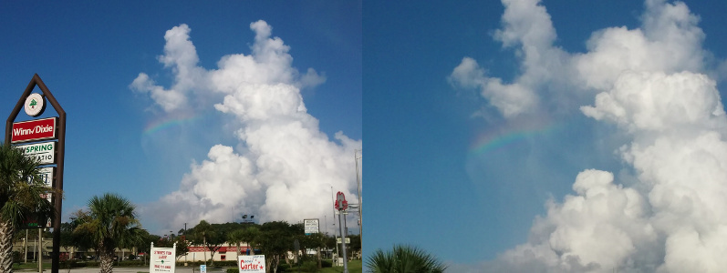 [Two images are spliced together. The left image is the street view with the store and road signs visible in the lower foreground and the rainbow swath amid the puffy white clouds in the blue sky. The image on the right is a closer view of the clouds and the horizontal rainbow stripe amid them. There are wisps of white coming from the upper cloud area and going through the rainbow, so it's possible the sun reflecting off the rain is causing the color. The rainbow is red at the top and progresses through the color spectrum to the violet at the bottom.]
